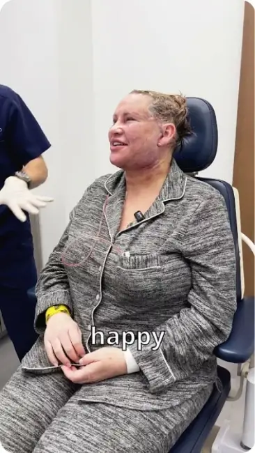 Woman in pajamas smiling in a medical office chair with happy text.
